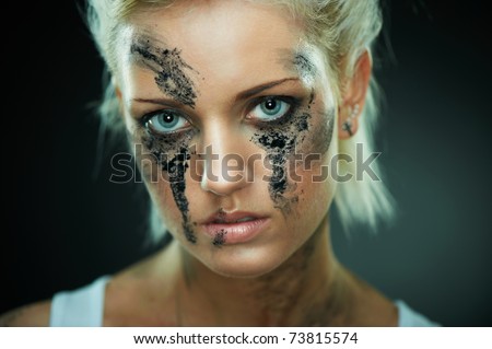 Closeup portrait of a depressed beautiful girl with dirty face, shallow DoF