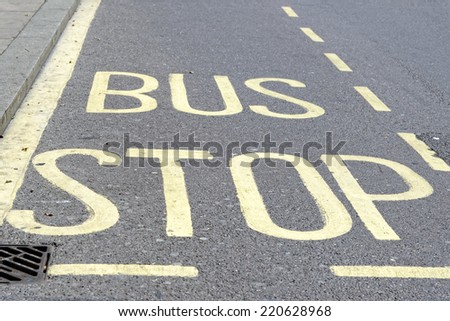 Yellow painted bus stop sign on a street