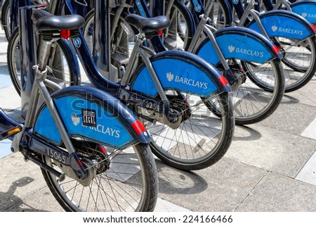 LONDON, ENGLAND - JULY 1, 2014: Shared bikes are lined up in the streets of London. Barclays Cycle Hires, launched in July 2010, has over 720 stations and 10,000 bikes throughout London.