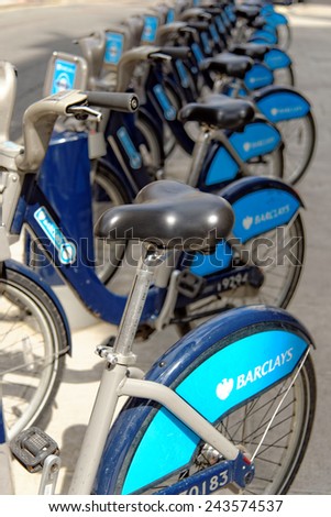 LONDON, ENGLAND - JULY 1, 2014: Shared bikes are lined up in the streets of London. Barclays Cycle Hires, launched in July 2010, has over 720 stations and 10,000 bikes throughout London.