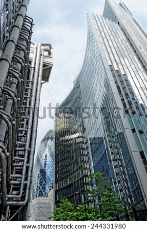 LONDON, UK - JULY 1, 2014: The famous office buildings - The Willis and the Lloyds building the Gherkin Tower in the distance in the City of London, one of the leading centers of global finance