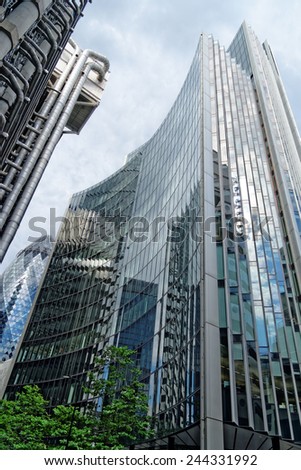 LONDON, UK - JULY 1, 2014: The famous office building - The Willis and the Gherkin Tower in the distance in the City of London, one of the leading centers of global finance.