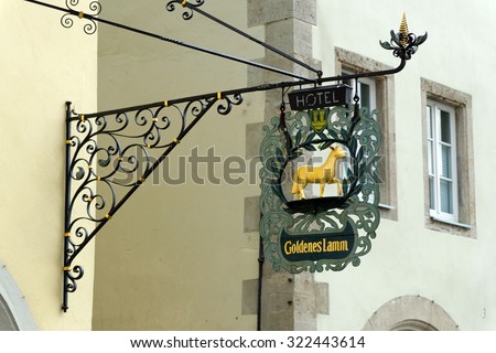 ROTHENBURG OB DER TAUBER, GERMANY - AUGUST 10, 2015: A hotel wrought iron hanging sign in Rothenburg, one of the best-preserved medieval towns in Europe, part of the famous Romantic Road tourist route