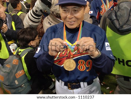 Japan coach Sadaharu Oh displays his gold medal earned for winning the 2006 World Baseball Classic after they defeated Cuba 10-6 at Petco Park in San Diego March 20, 2006.