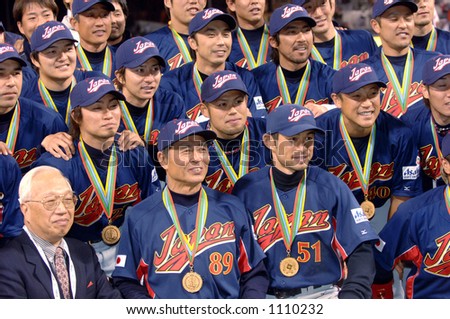 Team Japan poses for pictures during celebrations following their 10-6 victory over Cuba to win the 2006 World Baseball Classic at Petco Park in San Diego March 20, 2006.