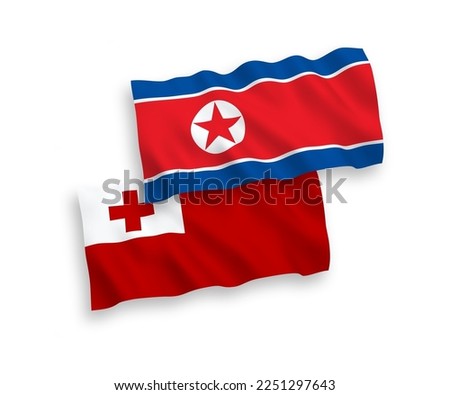 National vector fabric wave flags of North Korea and Kingdom of Tonga isolated on white background. 1 to 2 proportion.