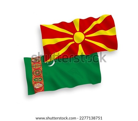 National vector fabric wave flags of Turkmenistan and North Macedonia isolated on white background. 1 to 2 proportion.