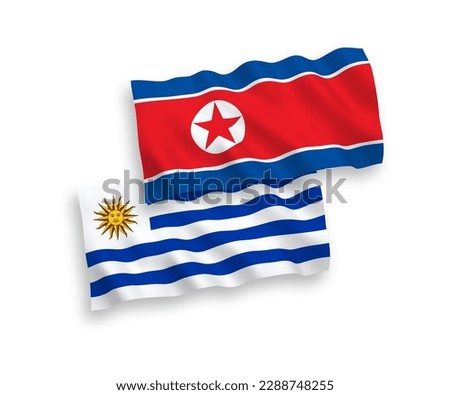 National vector fabric wave flags of North Korea and Oriental Republic of Uruguay isolated on white background. 1 to 2 proportion.