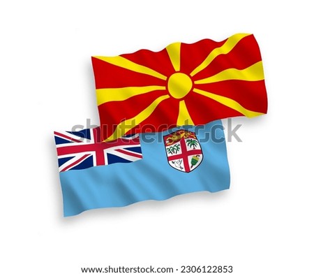 National vector fabric wave flags of Republic of Fiji and North Macedonia isolated on white background. 1 to 2 proportion.