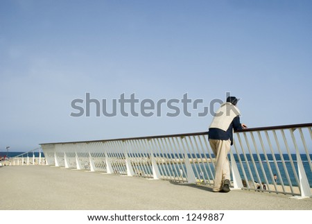 man watching people in the beach with blue sky