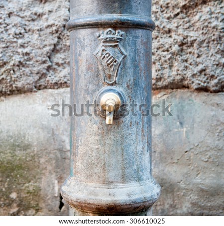 Detail of old aged typical roman fountain for drinkable water with SPQR sign