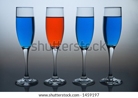 Wineglasses filled with colored liquid - illustrating concepts such as Workplace Diversity or Deomocrat versus Republican.