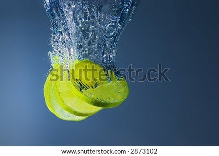 Fresh lime slices falling into water. A delicious and nutritious snack.
