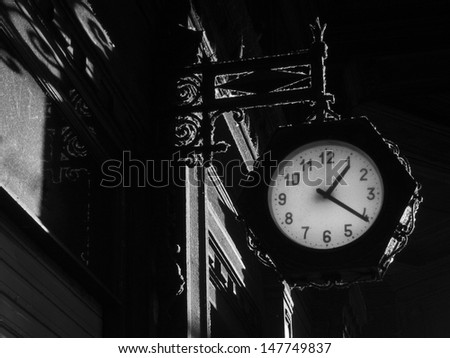 Street old clock on the dark wall