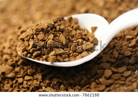 Morning background with coffee (close-up of soluble coffee grain and spoon).