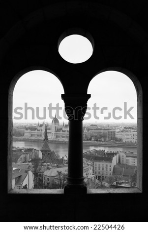 View of the Parliament building and Danube river from window of Buda Castle Fishermen\'s Bastion (Budapest, Hungary)