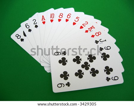 bridge playing - one hand (8,6,2 spades, A,10,8,6,5,2 hearts, K,8 diamonds, J,9 clubs)  background green, selective focus,