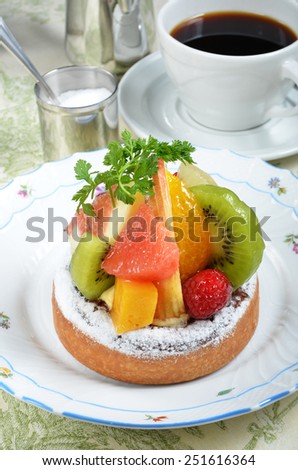 Fresh fruit tart with kiwi, apple, mango, orange and strawberry.