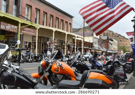 VIRGINIA CITY, NV  JUNE 6, 2015: Motorcycles park along the street amid old western buildings during the seventh annual public Street Vibrations Spring Rally in Virginia City, Nevada on June 6, 2015.