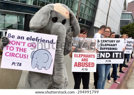 LOS ANGELES, CA â?? JULY 9, 2015: A protestor in an elephant costume joins other activists holding signs denouncing animal treatment by Ringling Bros. Circus on July 9, 2015 in Los Angeles, California.