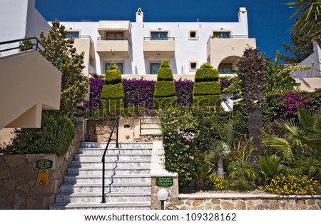 typical vacation hotel apartments with beautifully maintained garden areas on the greek island of rhodes