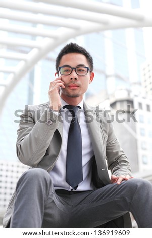 Asian business man speaking mobile phone