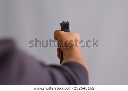 Hand holding gun