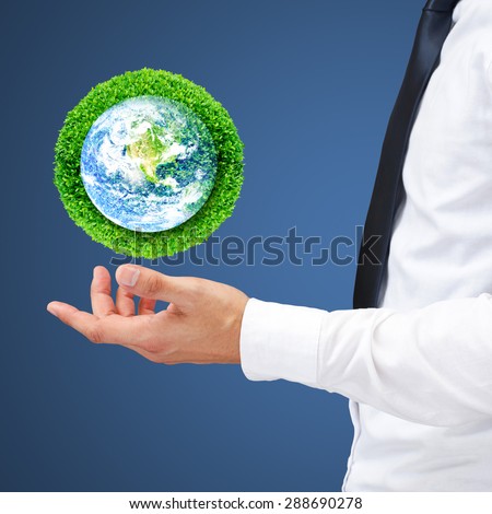 Save the earth by trees. Human hand holding global with green tree for think earth concept. Elements of this image furnished by NASA.