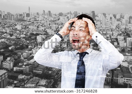Double exposure of Businessman crying and holding his head in hands.