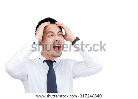Businessman crying and holding his head in hands on while background.