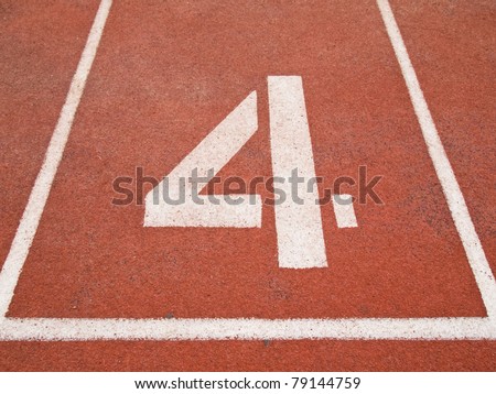 Number four on the start of a running track
