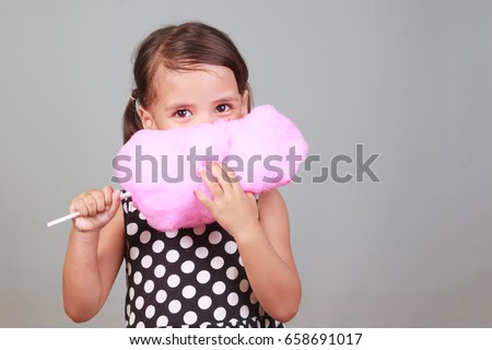 Similar – Image, Stock Photo Cheerful girl eating cotton candy on street