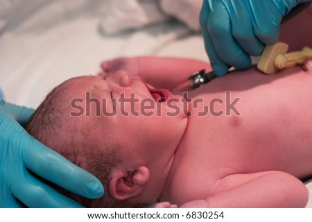 Newborn baby being examined right after birth