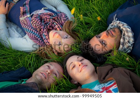 boys and girls lie down in the park