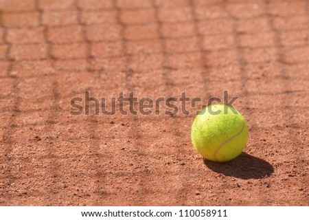 Tennis ball on the floor in a clay court