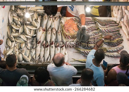 RIO DE JANEIRO, RJ/Brazil - APRIL 03, 2015:  Selling fish in the popular market St. Peter during the Holy Week holiday. Buyers in front of the fish counter