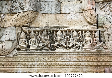 Ancient Khmer carving of Apsara dancing goddesses.  One of many similar friezes in the Hall of the Dancers in Preah Khan Temple, Angkor, Cambodia.   Ancient carving, hundreds of years old