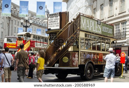 LONDON, ENGLAND - JUNE 22, 2014:  Spectators enjoying the cavalcade of historic buses along Regent Street, Westminster as London Transport celebrates the bicentenary of London Buses.