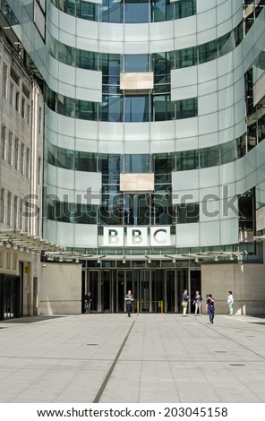 LONDON, ENGLAND - MAY 18, 2014: Workers at piazza and entrance to  BBC New Broadcasting House in London.  The building houses journalists and programme makers together with broadcasting studios.