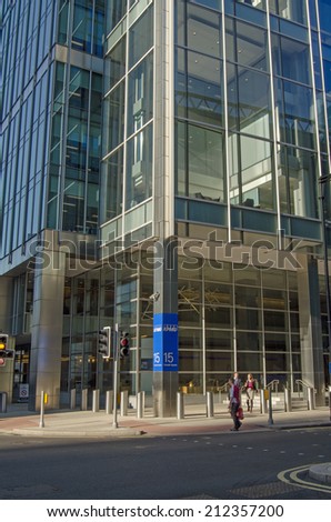 LONDON, UK - JULY 1, 2014:  Pedestrians outside the offices of accountancy firm KPMG in the Canary Wharf district of London Docklands.