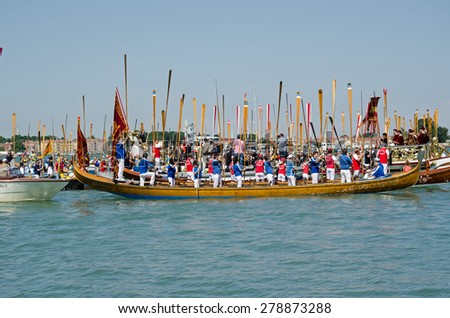 VENICE, ITALY - MAY 17, 2015:  Rowers standing with their oars to attention during the Marriage with the Sea ceremony, part of Festa della Sensa to mark Ascension Day in Venice Lido.