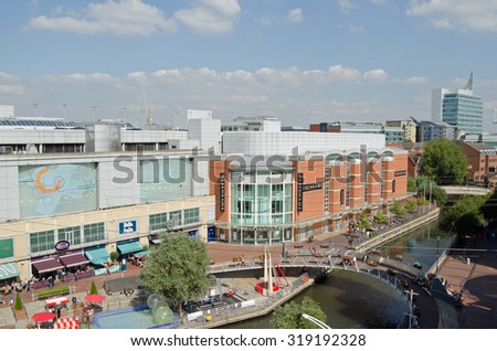 READING, UK - SEPTEMBER 10, 2015:  Aerial view of the River Kennet in the centre off Reading, Berkshire as pedestrians and shoppers enjoy the early afternoon sunshine at the Oracle Shopping Centre.