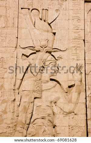 Large stone carving of the ancient egyptian goddess Ma\'at, Temple of Horus, Edfu, Egypt.  Ma\'at is the goddess of truth, justice and harmony and has feathers in her hair.