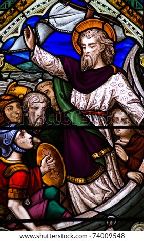 Victorian stained glass window depicting Jesus Christ with his disciples on a boat on the sea of Galilee during a storm. Victorian window, over 100 years old.