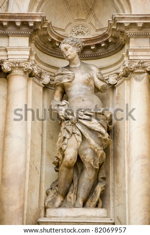 Statue of a beautiful woman representing a virtue.  Facade of the baroque Scalzi church in in Cannaregio, Venice, Italy.