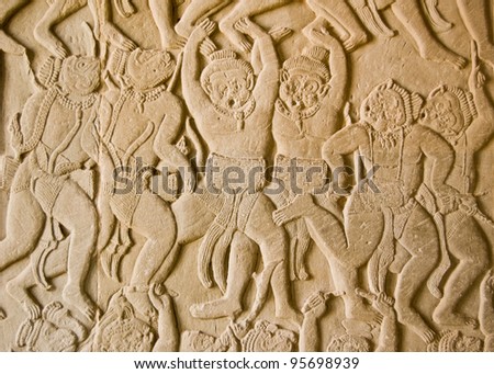 Ancient Khmer bas relief carving showing the monkey army of the Hindu god Hanuman whooping as they go into battle.  Angkor Wat temple, Siem Reap, Cambodia.
