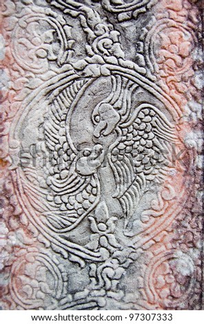 Ancient bas relief carving of two parrots gazing at each other.  Pillar at Bayon Temple, Angkor Thom, near Siem Reap, Cambodia.