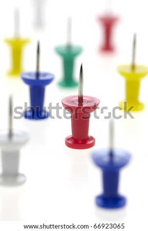 colorful push pins - multicolored pins isolated on white