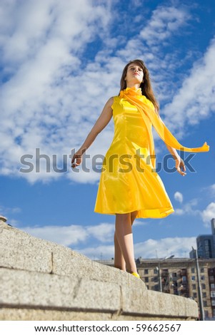 pretty woman in yellow dress looking away