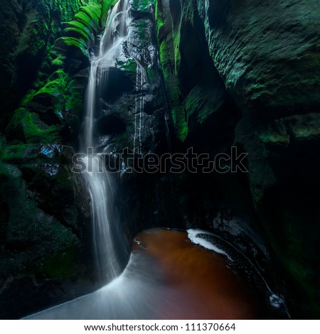 Panoramic view of a beautiful spring waterfall, square format.
